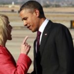 President Obama and Arizona Governor Jan Brewer speaking face to face on an airport tarmac, Brewer pointing a finger toward him