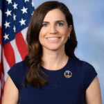 Official congressional portrait of Rep. Nancy Mace, Republican of South Carolina, seated before an American flag.