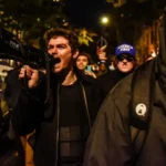 Nick Fuentes, the white-nationalist streamer whose online following calls itself the groypers, speaking into a microphone.